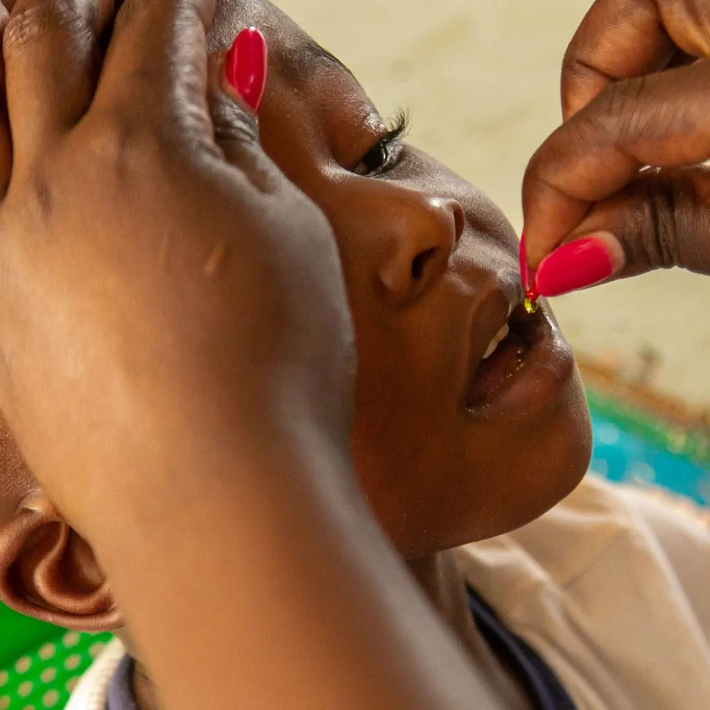 child taking a vitamin supplement