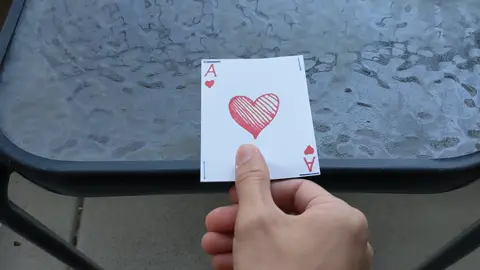 Animation of someone trying to flip a card over without it leaving the table goes poorly.